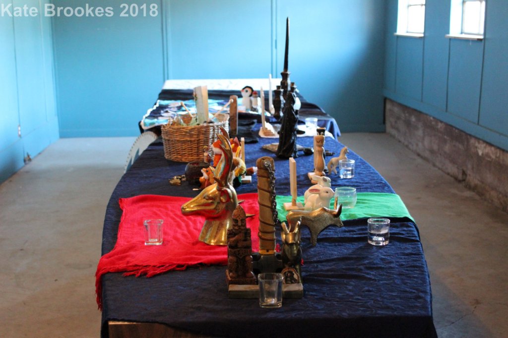 Ves (shrines) to the 13 deities of the Freehold Pantheon arranged around a table during the 2018 Althing.